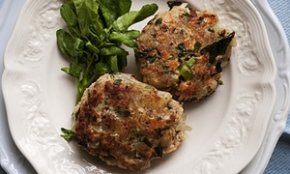 Salmon, crushed potatoes and watercress fishcakes on a plate